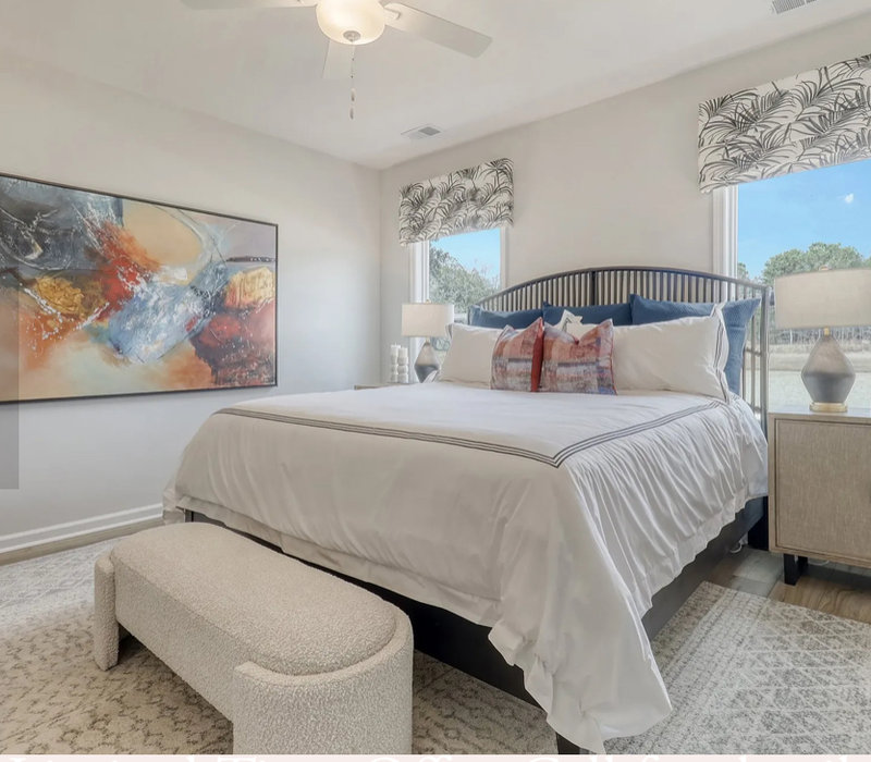 Bedroom with upholstered bench and abstract art
